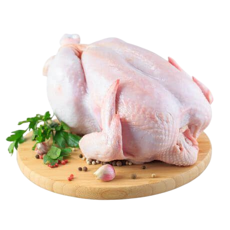 Whole raw chicken on wooden board with herbs and garlic cloves